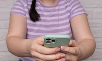 How can I prevent my child from making mini transactions or purchases on an iPhone or iPad?